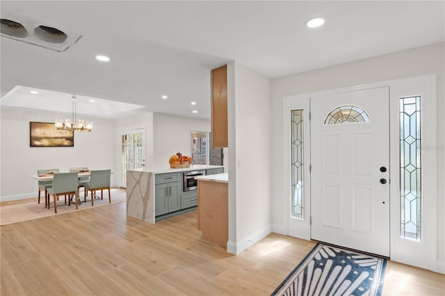 foyer featuring light hardwood / wood-style floors and a notable chandelier