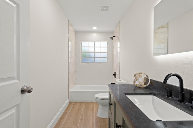 full bathroom featuring vanity, hardwood / wood-style floors, toilet, and shower / bath combination