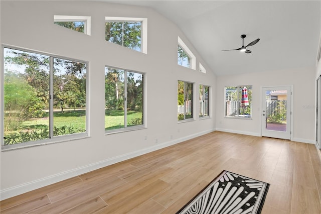 unfurnished sunroom with ceiling fan and vaulted ceiling