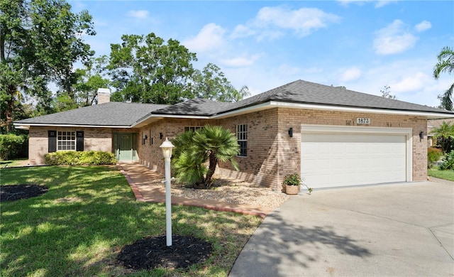 ranch-style home with a front yard and a garage