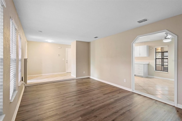 empty room featuring wood-type flooring and ceiling fan