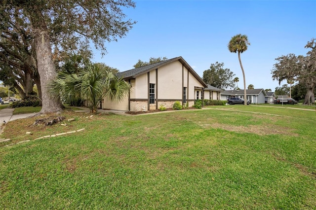 view of side of property with a lawn