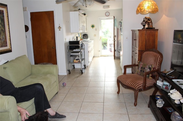 living room featuring ceiling fan and light tile patterned floors