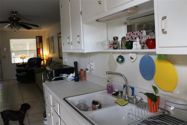 kitchen featuring sink, white cabinets, ceiling fan, and tile patterned flooring