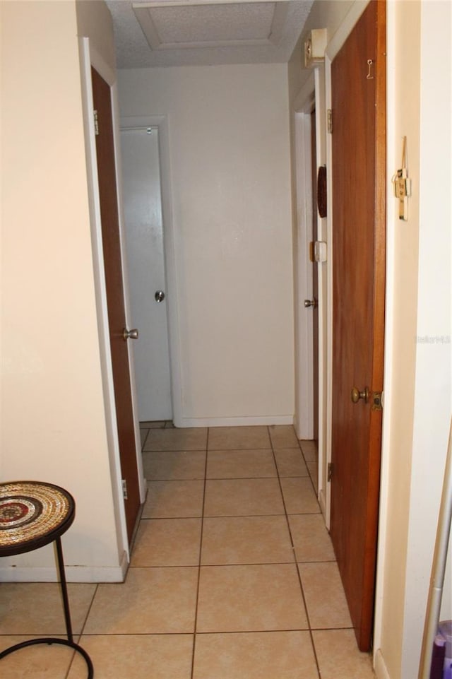 hallway with light tile patterned floors