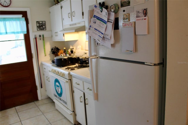 kitchen featuring white cabinetry, light tile patterned floors, and white appliances