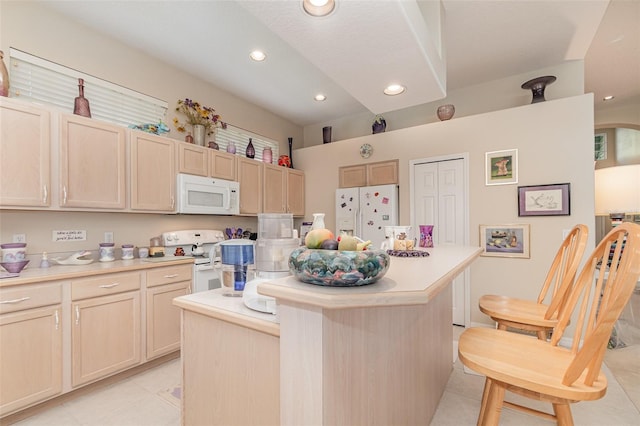 kitchen featuring white appliances, light tile patterned floors, a center island, and light brown cabinets