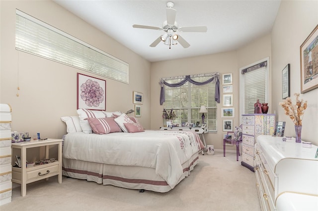 bedroom with light carpet and ceiling fan