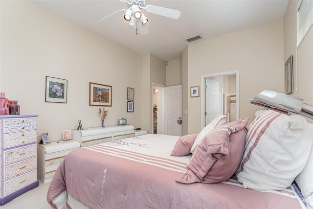 carpeted bedroom featuring a towering ceiling and ceiling fan