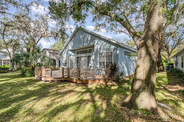 back of house with a yard, a deck, and cooling unit