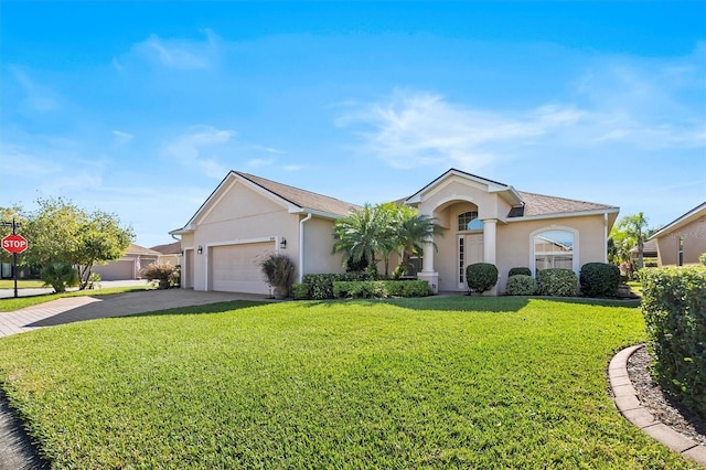 single story home featuring a garage and a front lawn