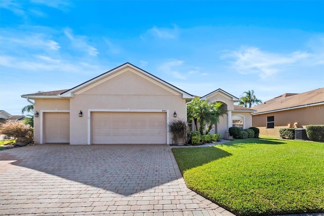 single story home featuring a garage, central air condition unit, and a front yard