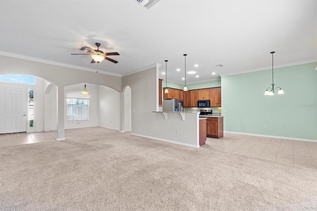 unfurnished living room featuring ceiling fan with notable chandelier, light colored carpet, and crown molding