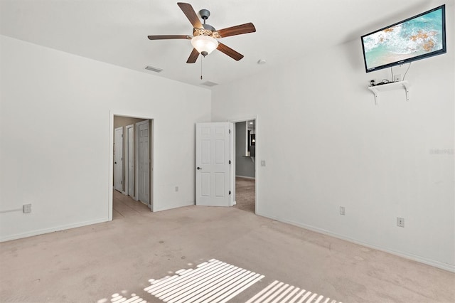 carpeted empty room with ceiling fan