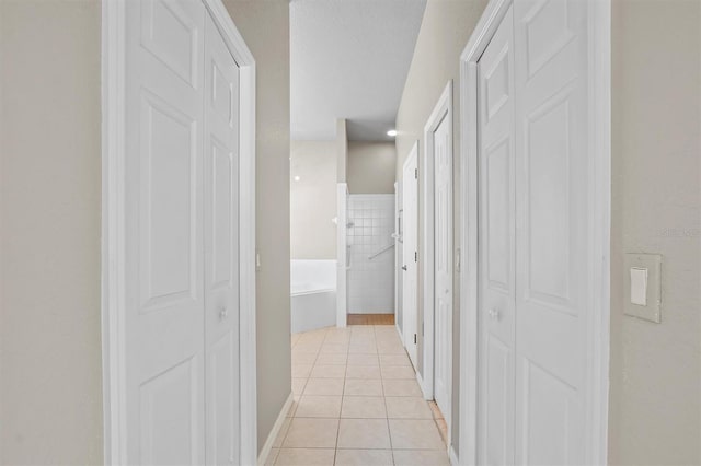 hall featuring light tile patterned floors