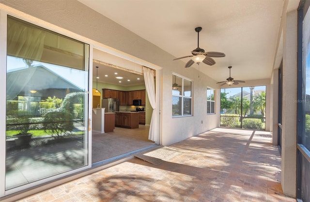 view of patio / terrace with ceiling fan and an outdoor kitchen