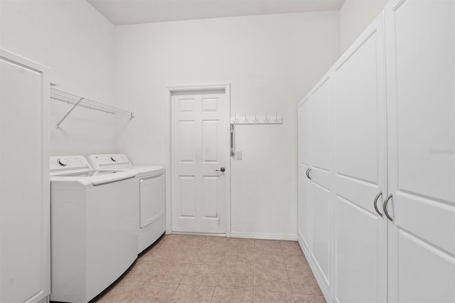 laundry area featuring washing machine and dryer and light tile patterned floors