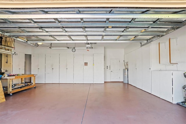 garage with electric water heater and a garage door opener