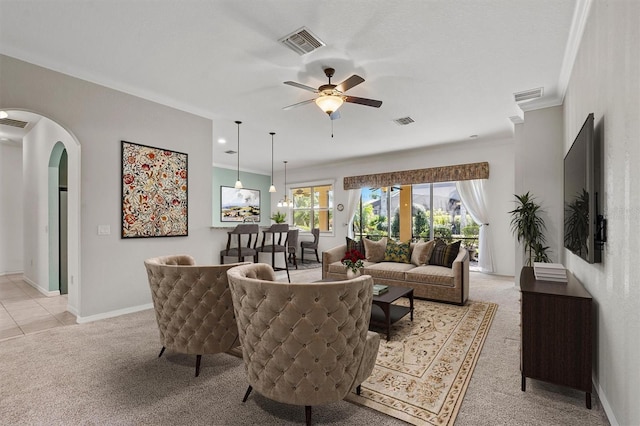 carpeted living room featuring ceiling fan and ornamental molding