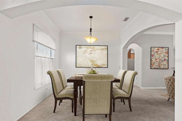 dining space with light colored carpet and crown molding