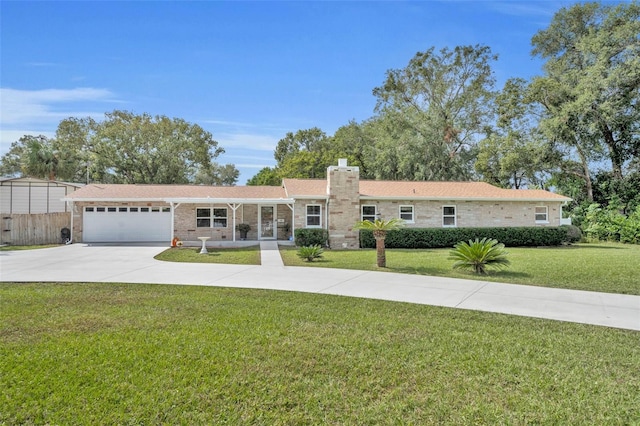 ranch-style house with a garage and a front lawn