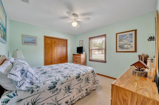 carpeted bedroom featuring a closet and ceiling fan