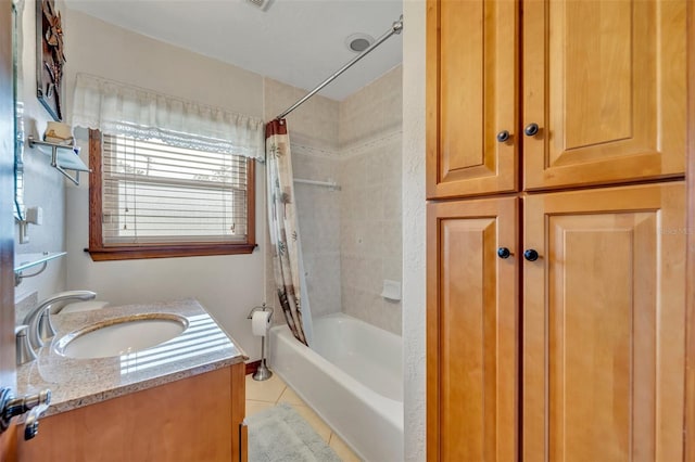 bathroom featuring tile patterned floors, shower / bath combo with shower curtain, and vanity