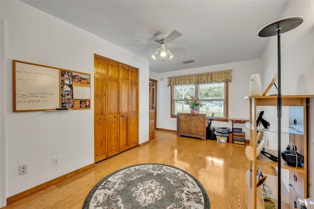 interior space featuring wood-type flooring and ceiling fan