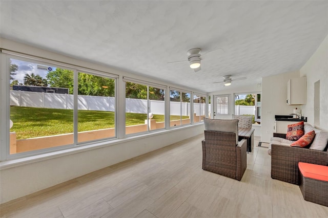 sunroom / solarium with ceiling fan and a wealth of natural light