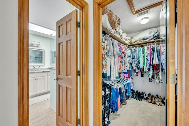 spacious closet featuring attic access and visible vents