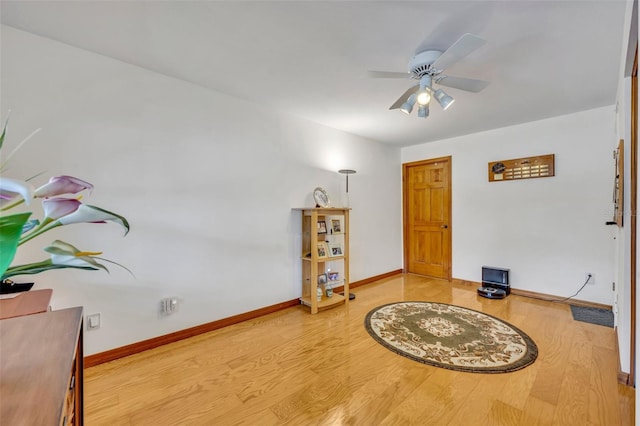 sitting room featuring ceiling fan, baseboards, and wood finished floors