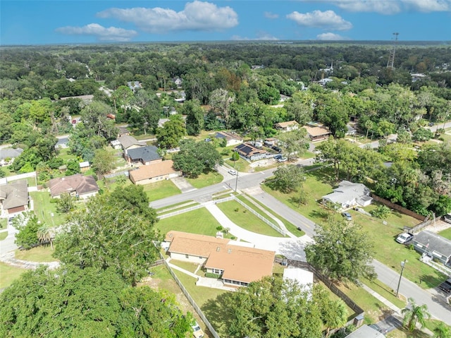 bird's eye view featuring a residential view and a wooded view