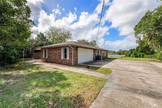 660 Saxon Blvd, Deltona, FL 32725 - view of home's exterior featuring brick siding, a garage, driveway, and a yard