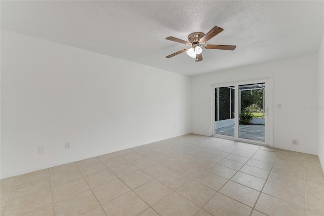 tiled spare room with ceiling fan and a textured ceiling