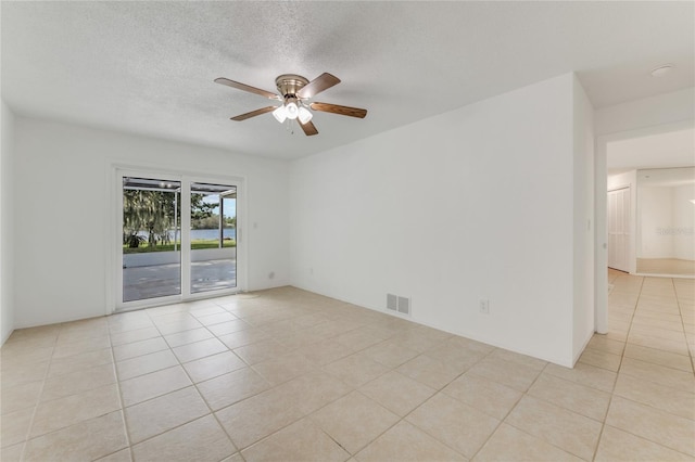 660 Saxon Blvd, Deltona, FL 32725 - unfurnished room with light tile patterned floors, a ceiling fan, and a textured ceiling