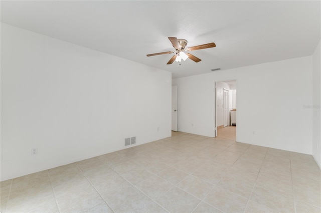 spare room featuring light tile patterned floors and ceiling fan