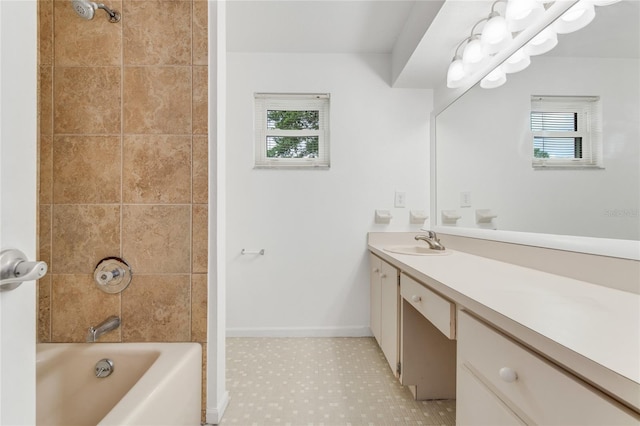 bathroom featuring vanity and tiled shower / bath