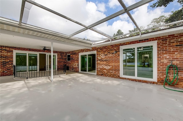 view of patio / terrace with glass enclosure and ceiling fan