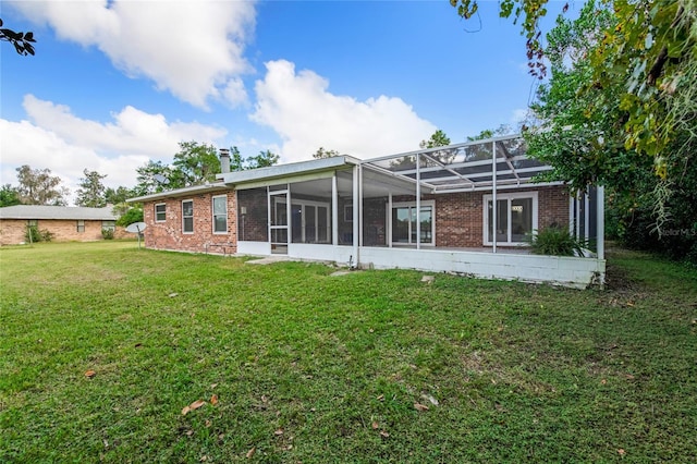 660 Saxon Blvd, Deltona, FL 32725 - rear view of house featuring a yard, brick siding, a chimney, and a lanai