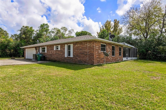 single story home featuring a garage, a front yard, and a sunroom