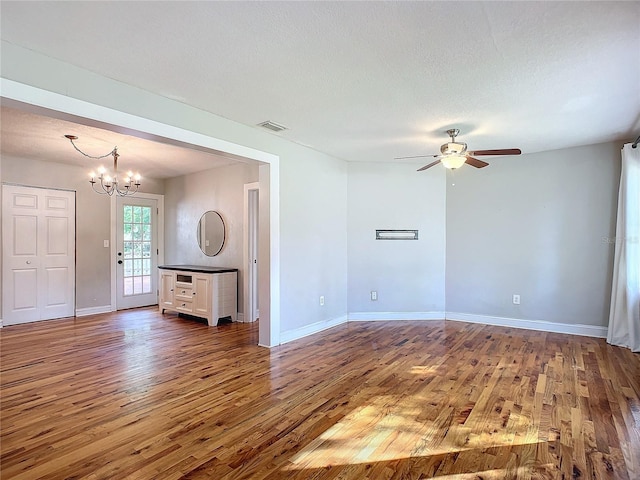 spare room featuring a textured ceiling and dark wood-type flooring