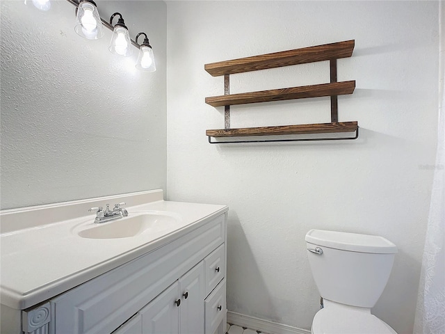 bathroom featuring toilet and vanity