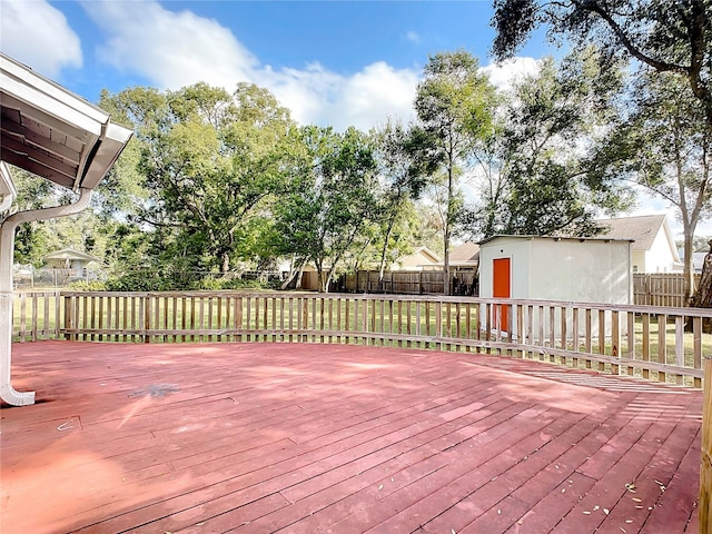 wooden terrace featuring a storage shed