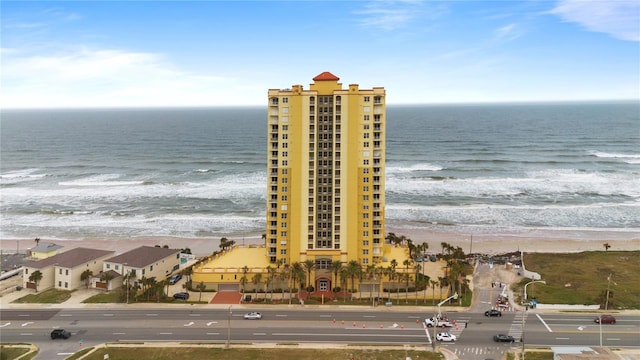 drone / aerial view with a water view and a view of the beach