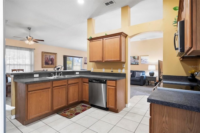 kitchen with sink, kitchen peninsula, stainless steel appliances, and light tile patterned floors