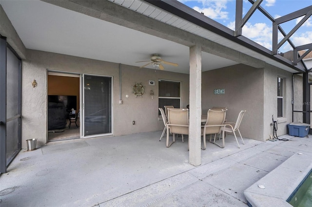 view of patio with ceiling fan and a lanai