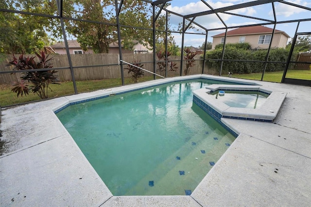 view of pool featuring an in ground hot tub, a patio, and a lanai