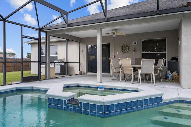 view of swimming pool with a patio, ceiling fan, an in ground hot tub, and glass enclosure