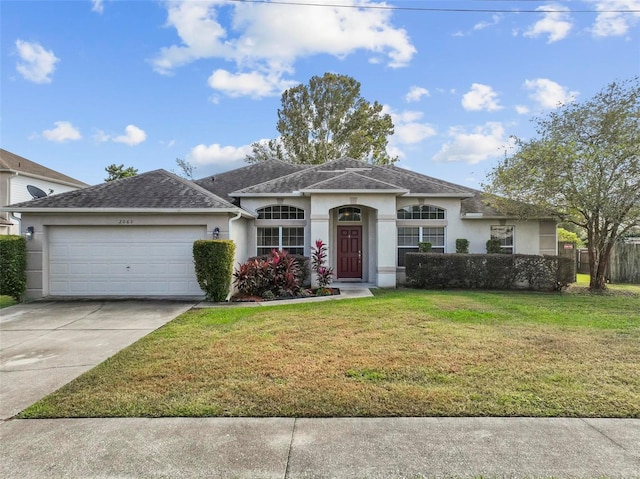 single story home with a front yard and a garage