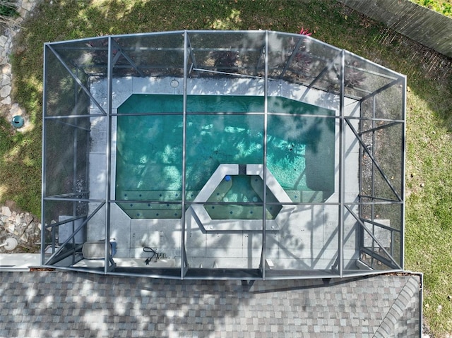 view of pool featuring glass enclosure